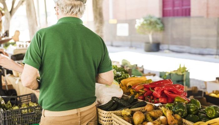 rear-view-senior-man-standing-vegetable-fruit-stall